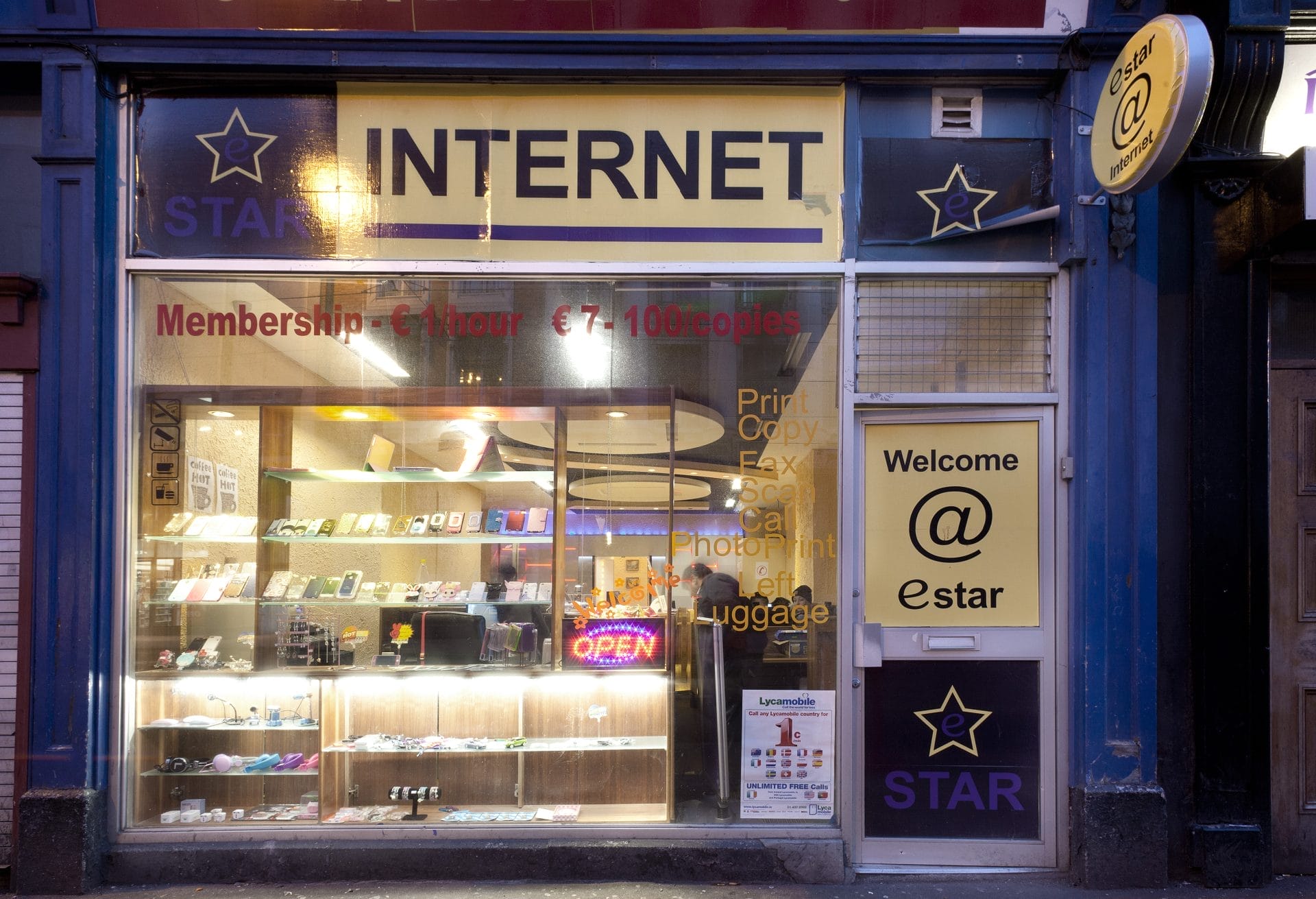 Colour photograph of front shop window of internet and multi purpose communications shop by Paul Tierney, photographer.