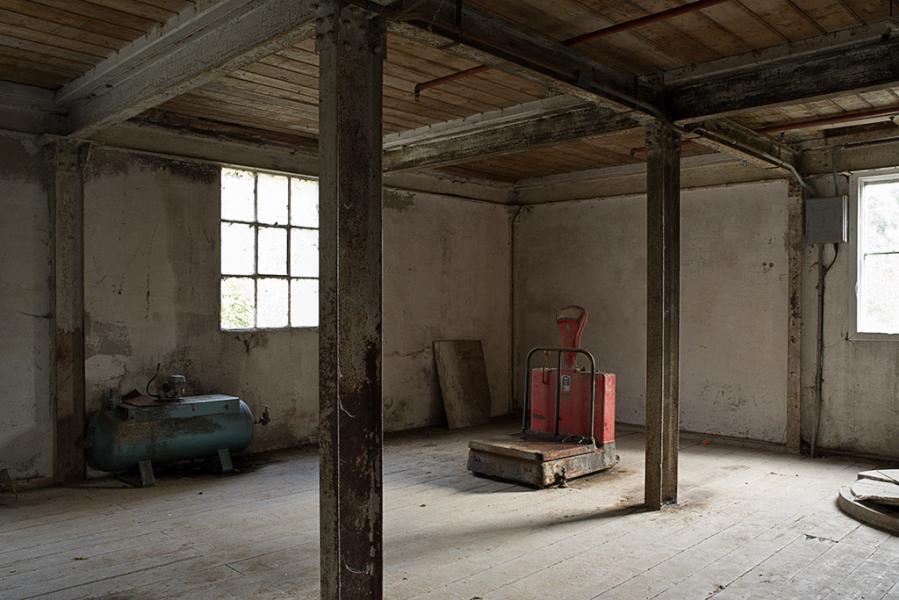 Colour photograph of the empty interior of the Shackleton Mill, Lucan, no longer in use, showing the large red Avery weighing scales, by Tim Durham, photographer.