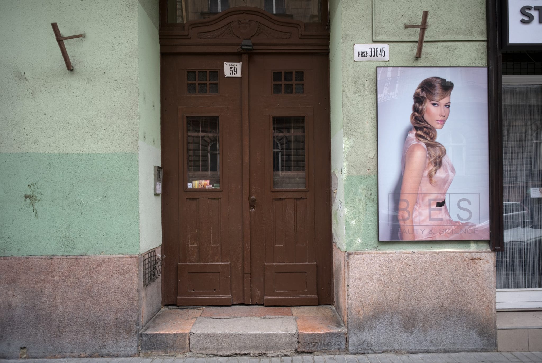 Colour photograph of the doorway of a yellow star house in Budapest, by Nigel Swann.