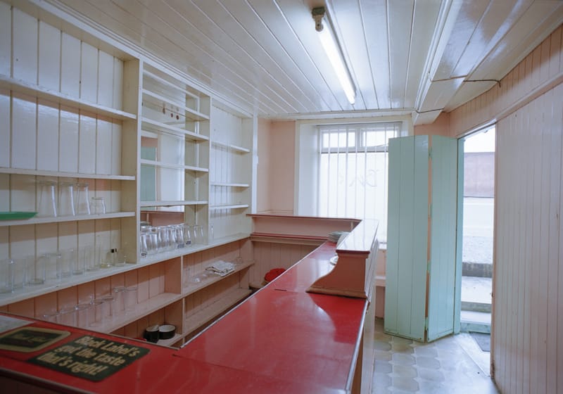 Colour photograph of the interior of Gillespie’s Pub, Mountcharles, Co. Donegal. The shelves are all empty.