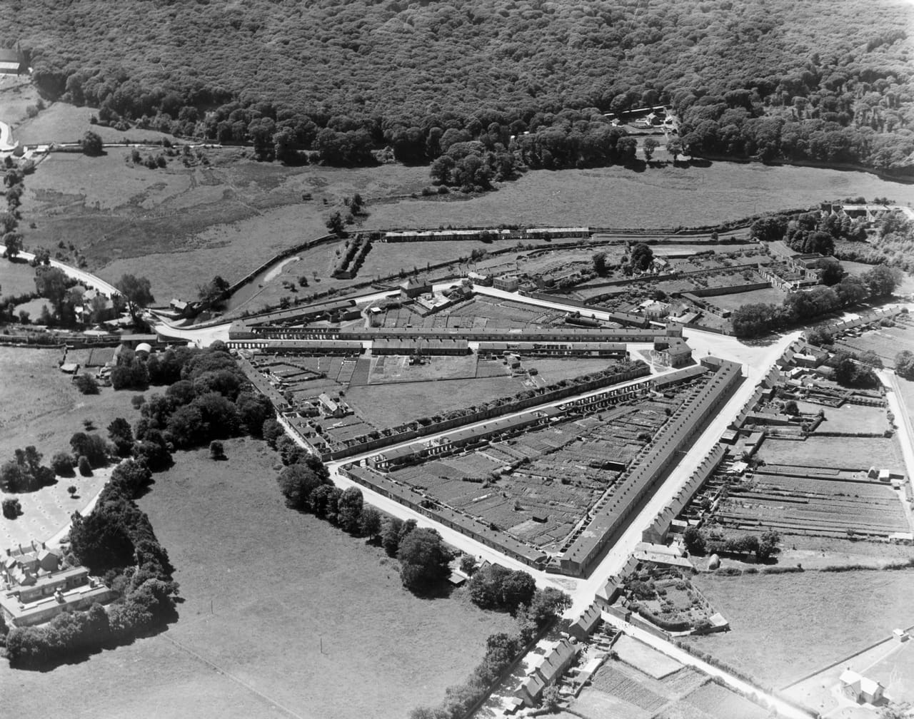 Oblique aerial photograph from the Historic England Aerofilms Collection showing Portlaw, Co. Waterford, taken facing south west in 1933.