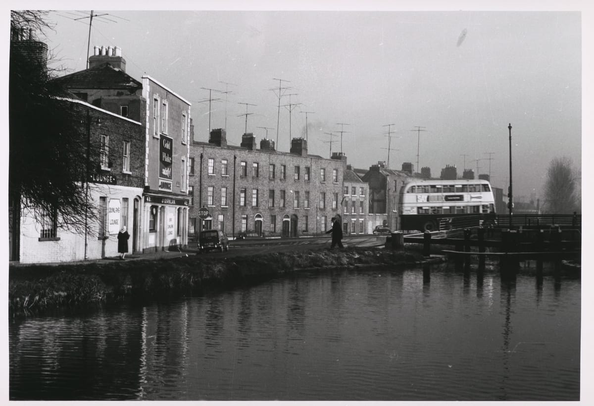 Photograph of Charlemont Place, Dublin, taken by Paddy Healy in 1964. The houses on Charlemont Place, with their proliferation of television aerials, no longer exist. The pub, however, survives.